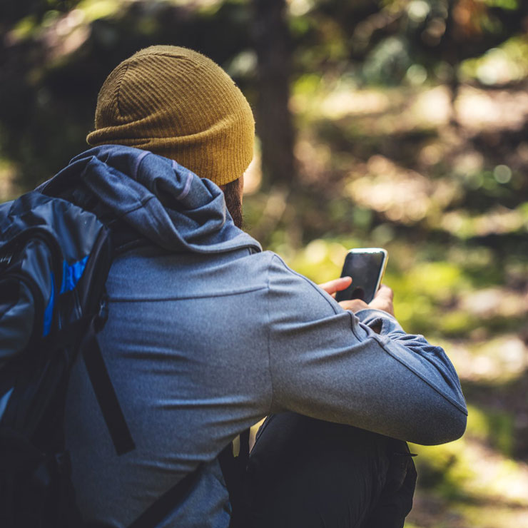 person looks at smartphone